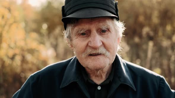 Wise man farmer in a hat looking to the camera. Real people concept. Agriculture concept