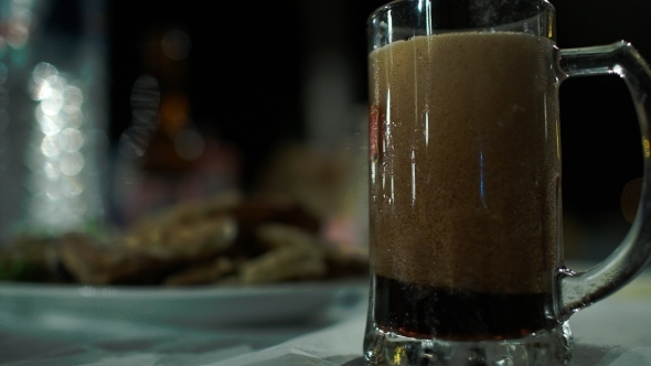 Pouring Dark Beer Into Glass Mug