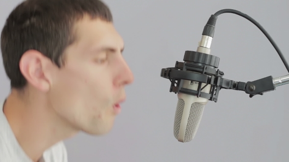 Man Singing At Studio Microphone.