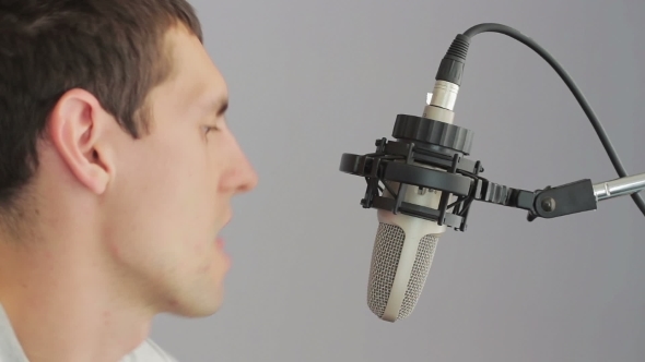 Man Singing At Studio Microphone.