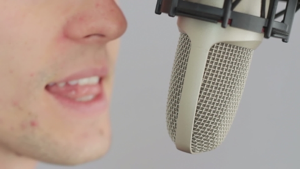 Man Singing At Studio Microphone.