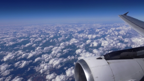 The Airplane Is Flying Above The Clouds