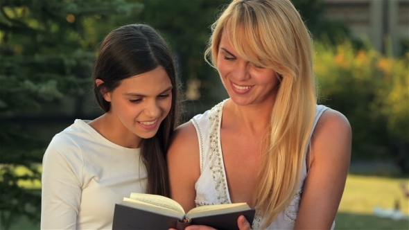 Reading a Book On a Bench Park alt