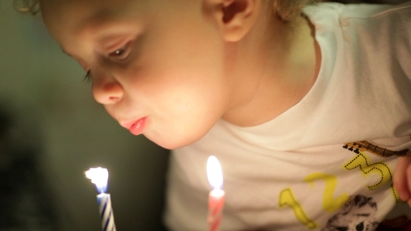 Little Boy Blowing Out The Candles.