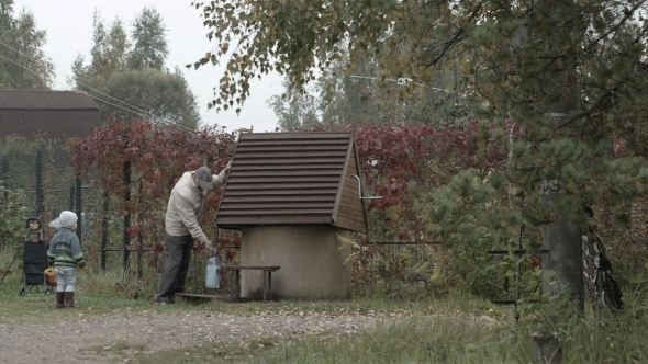 Grandfather And Grandson Near Well.