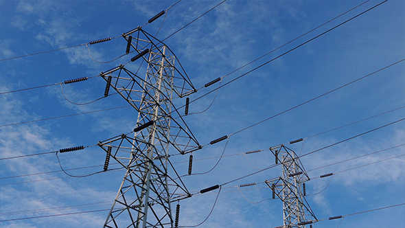 Couple Of Power Line Towers With Moving Sky alt