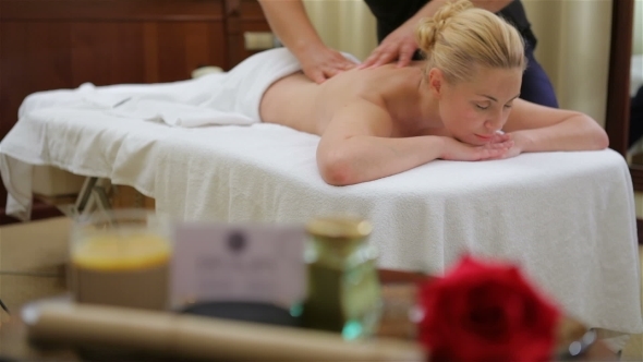 Woman Receiving Back Massage At Salon Spa