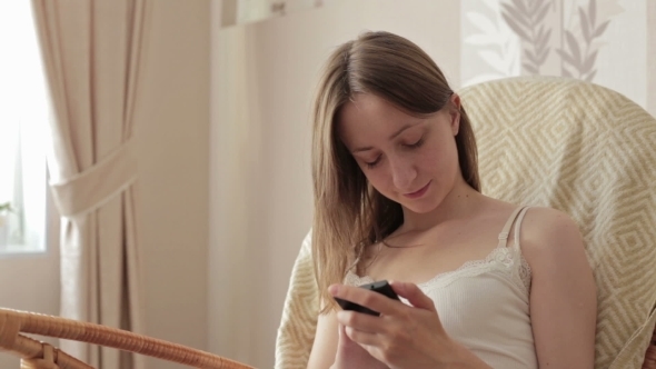 Young Beautiful Woman Sitting With Smart Phone.