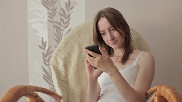 Young Beautiful Woman Sitting With Smart Phone.