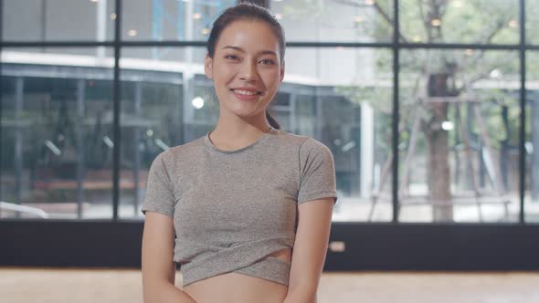 Korean girl relax toothy smile looking to camera while exercising healthy lifestyle.