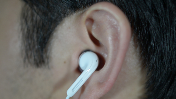 Man Putting Headphone in Ear