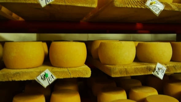 Cheeses Stored On Wooden Shelves