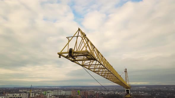 Aerial footage of a tower crane at construction site of new office building.