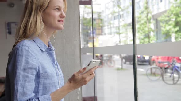 Happy businesswoman making phone call in coffee shop