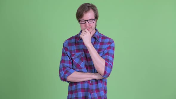 Stressed Young Hipster Man with Eyeglasses Thinking