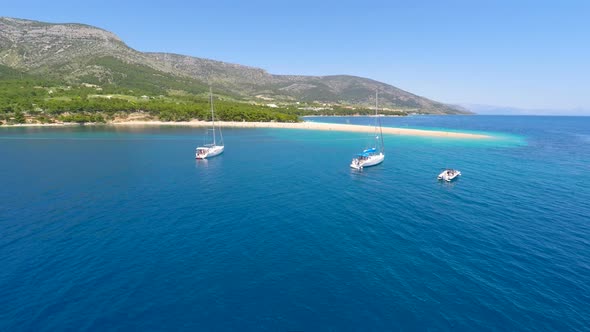 Aerial View Of Zlatni Rat Beach, Turquoise Sea And Yachts In Bol, Croatia. 1