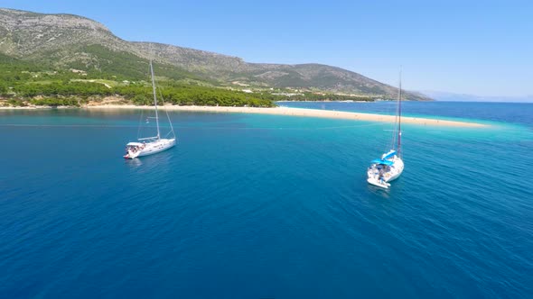 Aerial View Of Zlatni Rat Beach, Turquoise Sea And Yachts In Bol, Croatia. 2