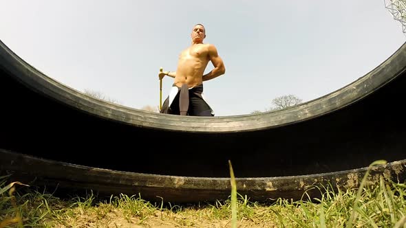 Close Up Of A Man Hitting Tire With A Hammer, Changing Hands 2 alt