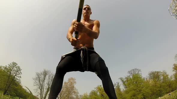 Close Up Of A Muscular Man Hitting With A Hammer alt