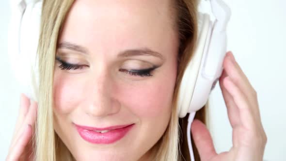 Close Up Of Beautiful Young Blond Woman Dancing With White Headphones 1