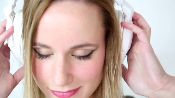 Close Up Of Beautiful Young Blond Woman Dancing With White Headphones 11