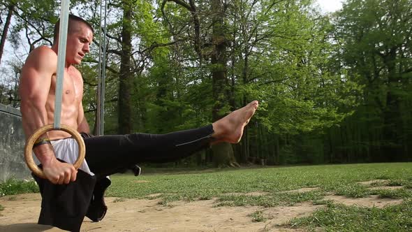 Close Up Of Muscular Man Doing Handstand On Gymnastics Rings