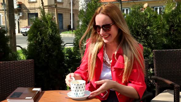 Young Happy Blond Woman Sitting In Coffee Shop, 1 alt