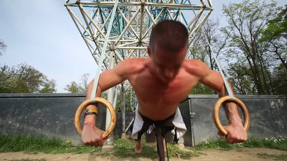 Close Up Of Muscular Man Doing Push Ups With Gymnastics Rings 2