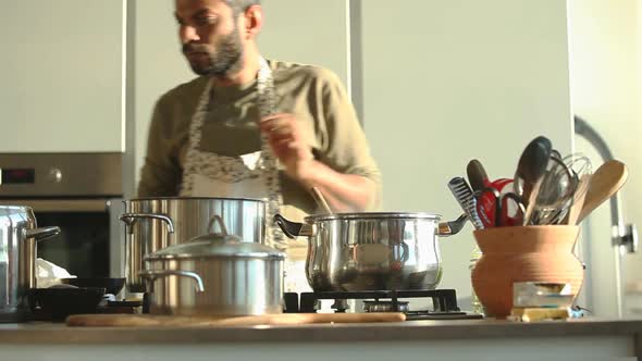 Young Indian Man Preparing Lunch In The Kitchen 10