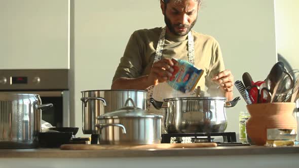 Young Indian Man Preparing Lunch In The Kitchen 11 alt