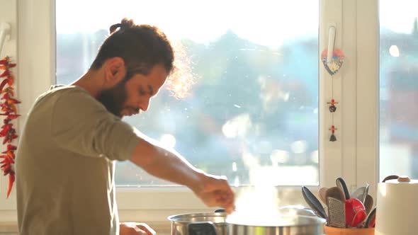 Young Indian Man Preparing Lunch In The Kitchen 2 alt