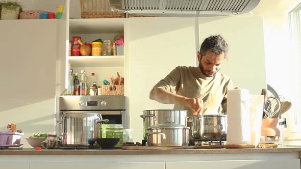 Young Indian Man Preparing Lunch In The Kitchen 6