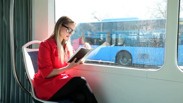 Beautiful Blond Woman Reading Book While Riding Tram 2