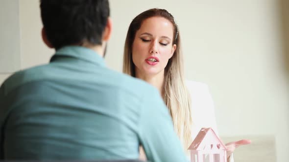Beautiful Blond Woman Talking To Man In Restaurant Environment 1 alt