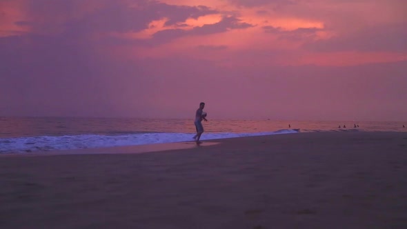 Hikkaduwa, Sri Lanka - February 2014: People Playing Sports On The Sandy Beach At Sunset. 2