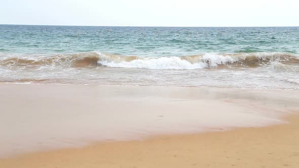 View Of Hikkaduwa Beach While Waves Are Splashing The Sand.