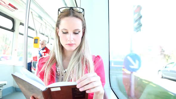 Beautiful Woman Riding Tram, While Reading Book 4