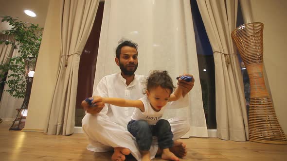 Indian Man With Kid Practicing Yoga 3