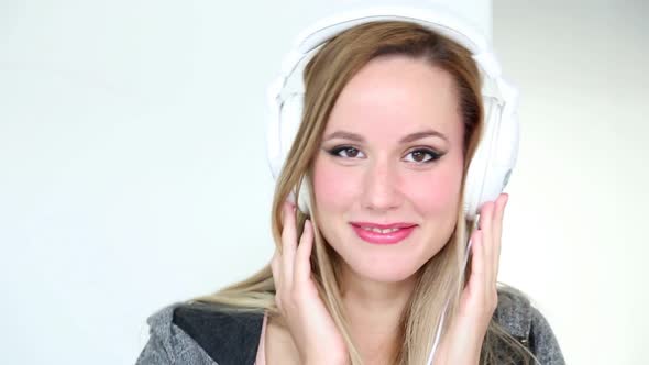 Beautiful Young Blond Woman Dancing With White Headphones 10