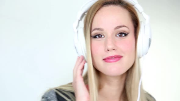 Beautiful Young Blond Woman Dancing With White Headphones 2 alt