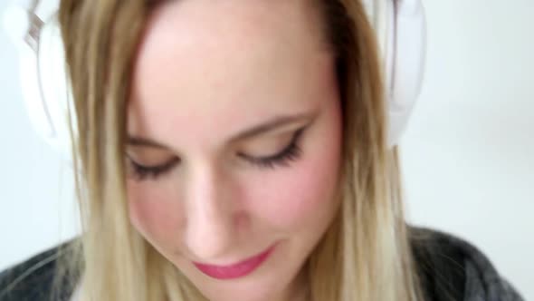 Beautiful Young Blond Woman Dancing With White Headphones 24 alt