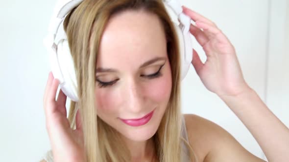 Beautiful Young Blond Woman Dancing With White Headphones 29