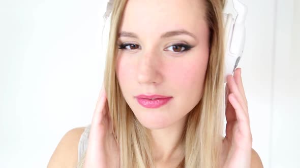 Beautiful Young Blond Woman Dancing With White Headphones 31