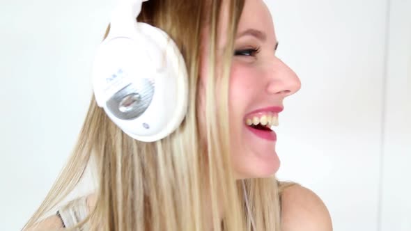 Beautiful Young Blond Woman Dancing With White Headphones 35