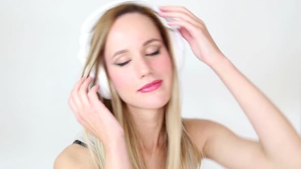 Beautiful Young Blond Woman Dancing With White Headphones 39