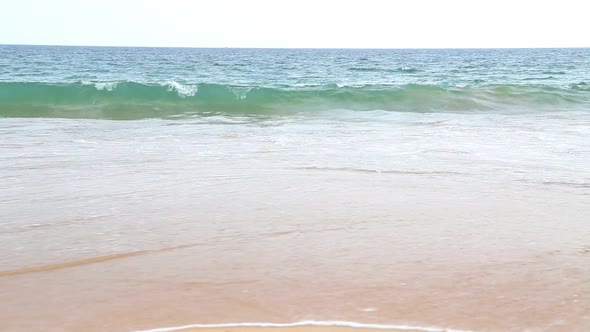 Waves Washing Up On Sandy Beach In The Tropics