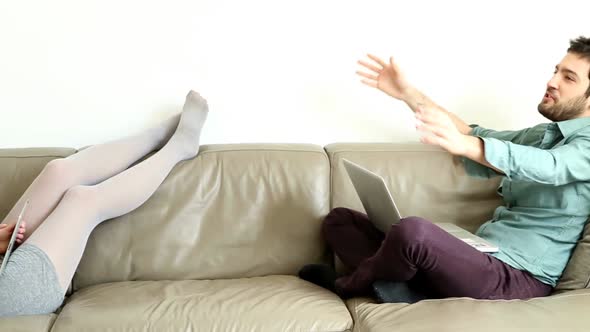 Woman And Man Hanging Out On Couch In Living Room 1