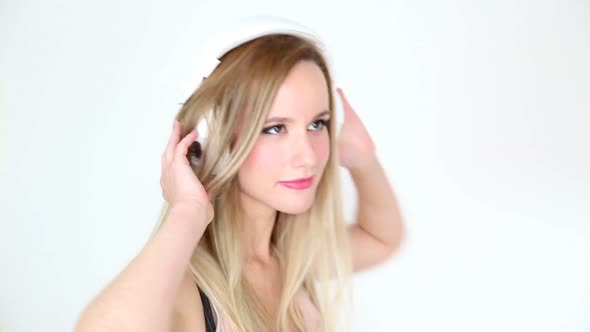 Beautiful Young Blond Woman Dancing With White Headphones 46