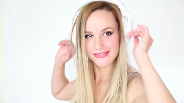 Beautiful Young Blond Woman Dancing With White Headphones 49