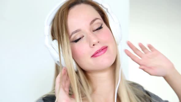 Beautiful Young Blond Woman Dancing With White Headphones 5